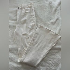 White flared jeans with rips